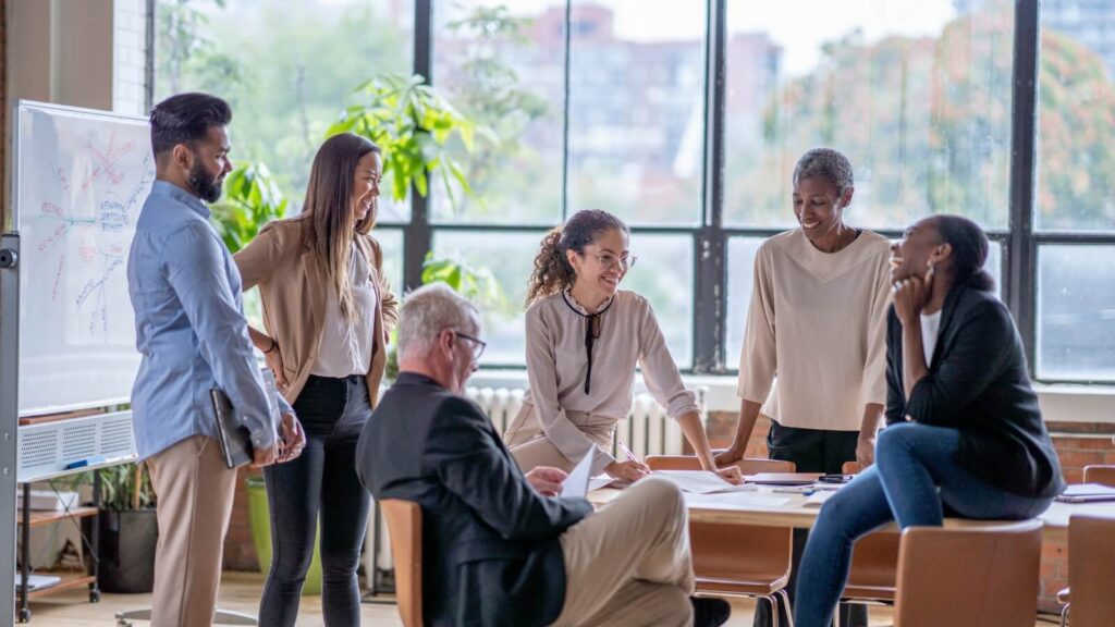 people standing around office desk