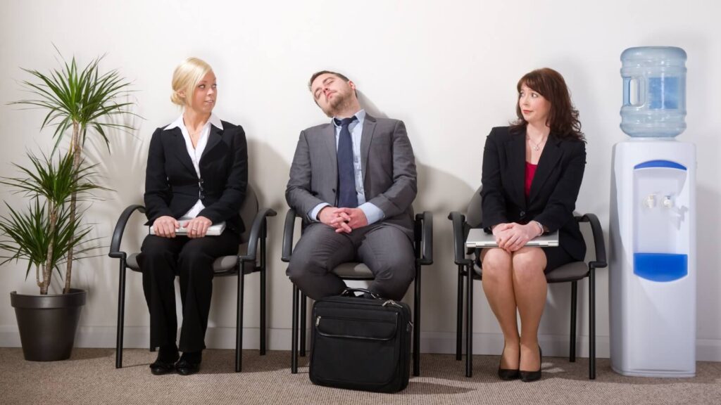 three professionals sitting in a waiting room area