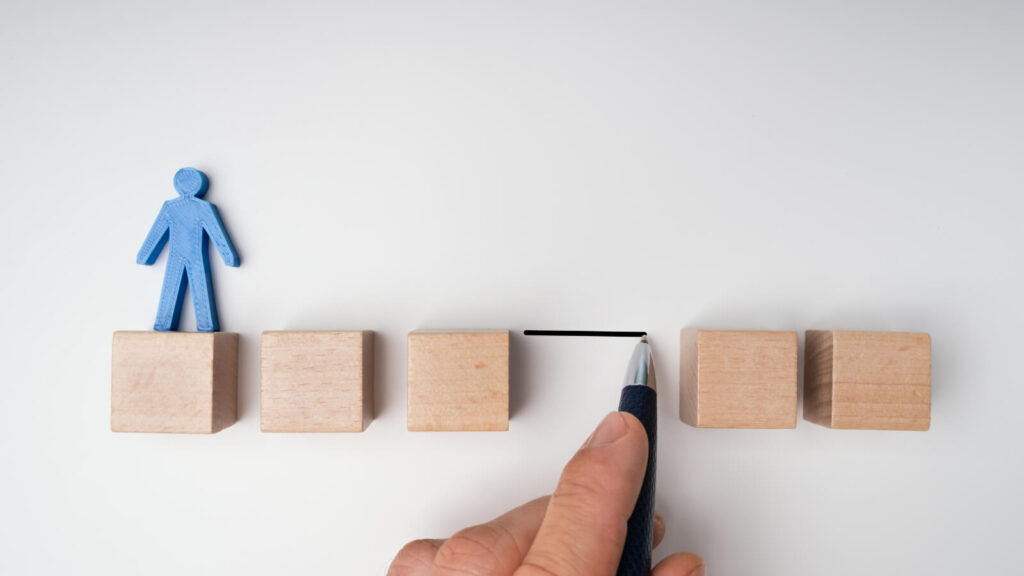 a blue person figure on wooden blocks