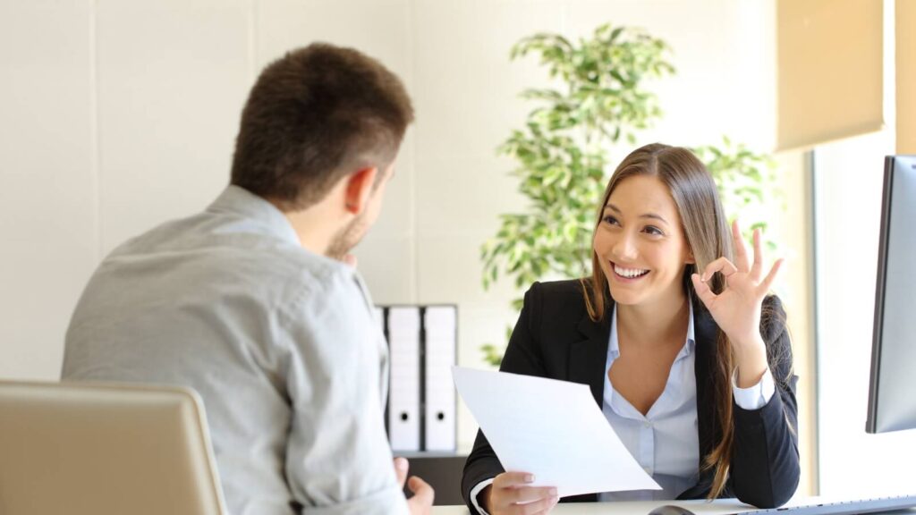 a man and woman chatting in an office