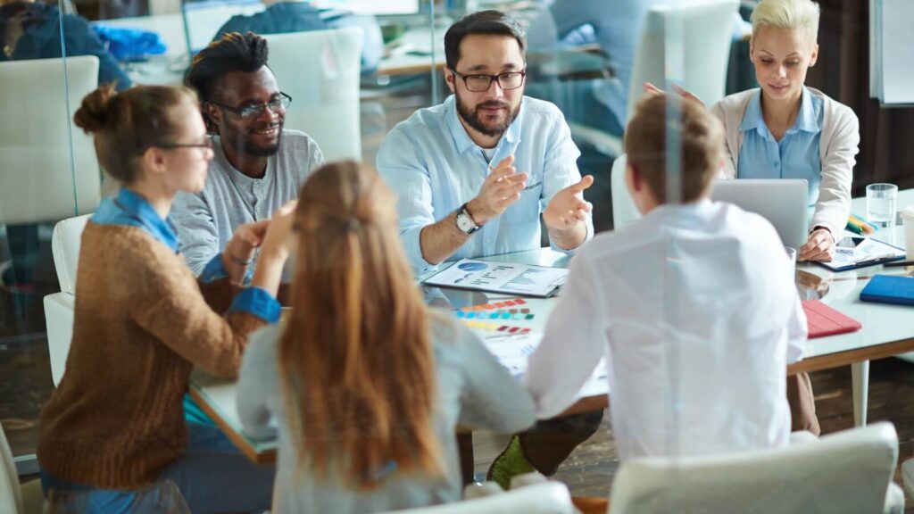 group of people sitting around a business table