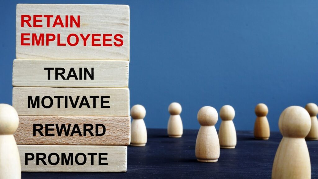 retain employees sign with wooden people
