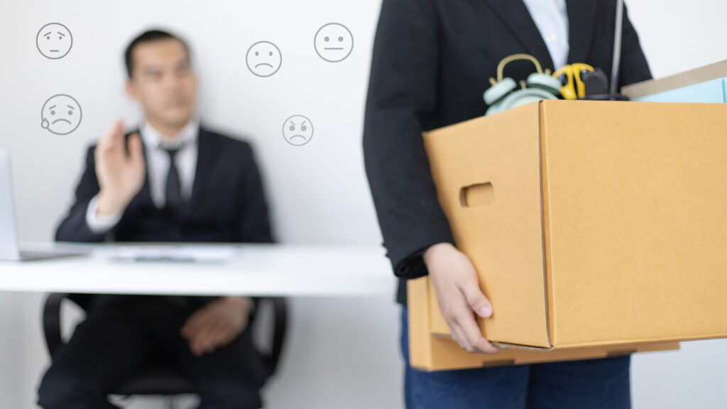 Closeup of employee leaving the office with a box